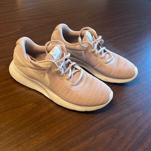 Pink women’s nike running shoe